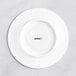 A white Acopa Cordelia saucer with black text reading "moon" in an embossed font.