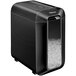 A black Fellowes paper shredder with a silver handle and clear container.