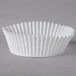 A close-up of a white fluted paper cupcake liner.