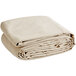 A stack of beige Monarch Brands heavyweight canvas drop cloths.