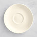 A white porcelain saucer with a circular rim.