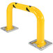 A yellow metal rack guard with black and yellow stripes on the base.