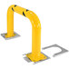 A yellow steel machinery and rack guard with two metal plates on the bottom.
