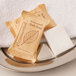 A silver tray with a group of white Ecossential Naturals hotel bath soap packages.