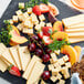 A plate of Daiya vegan smoked gouda cheese with fruit.