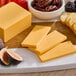 A cheese board with Daiya vegan cheddar cheese, fruit, and crackers.