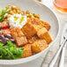 A bowl of Lightlife tempeh with chickpeas, greens, and tomatoes.