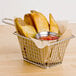 A basket of fries with ketchup on a table.