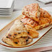 A white plate with David's Cookies Blueberry and Cinnamon Chip assorted scones on it.