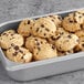 A baking tray filled with David's Cookies vegan preformed chocolate chip cookie dough cookies.