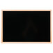 An oak-framed black marker board.