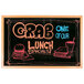 An Aarco oak-framed black marker board with white writing.