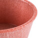 A close up of a red plastic ramekin.