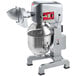 An Avantco commercial floor mixer with standard accessories and a shredder attachment on a stand with a metal bowl.