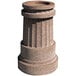 A stone pillar with a round bowl on top and a hole in the center.