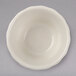 A Hall China American white flared ramekin on a gray surface.