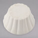 A white Hall China ramekin with a number on it.