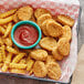 A tray of Rebellyous vegan Kickin' Chicken Nuggets and french fries with ketchup.