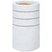 A white concrete cylinder with reveal lines filled with brown sand.