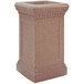 A Wausau Tile Cartier square concrete ash receptacle with a decorative design on a table outdoors.