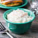 A bowl of coleslaw with a fork next to it.