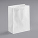 A customizable white paper bag with rope handles.