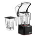 A black and clear Blendtec blender with a black sound enclosure and two black and clear containers on top.