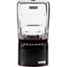 A black and clear Blendtec Stealth 885 blender with a black and red lid on a counter.