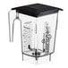 A clear Blendtec blender jar with a black lid and handle.