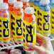 A person's hand holding a yellow C4 Energy drink bottle.