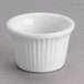 A Tuxton white fluted ceramic ramekin with ribbed edges.