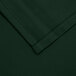 A close up of a hunter green rectangular cloth table cover.
