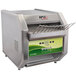 An APW Wyott conveyor toaster on a counter in a outdoor catering setup.