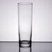 A Libbey Straight Sided Zombie Glass filled with water and a straw on a table.