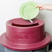 A hand using a San Jamar KatchAll Flatware Retriever Lid to dispose of a plate with a knife.