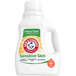 A white bottle of Arm & Hammer Perfume and Dye Free HE Liquid Laundry Detergent with a label.