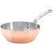 A de Buyer copper stir fry pan with a stainless steel handle.