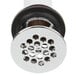 A close-up of a chrome T&S drain with grid over holes.