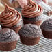 Chocolate cupcakes made with Pillsbury Bakers' Plus Devil's Food Cake Mix on a cooling rack.