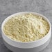 A bowl of Gold Medal yellow cake mix in a bowl on a gray surface.