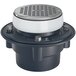A Zurn floor drain with a white lid and black base and a silver round strainer.