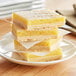 A stack of lemon bars on a plate.