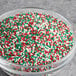 A bowl of Christmas nonpareil mix with red, green, and white candy sprinkles.