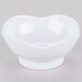 A white melamine bowl with a scallop shaped edge.