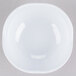 A white scallop shaped melamine bowl.