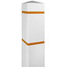 A white square bollard cover with yellow reflective stripes over a white bollard.