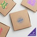 A group of Choice customizable kraft pizza boxes with blue logos.