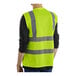 A person wearing a Lavex Class 2 lime high visibility safety vest with zipper closure.