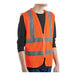 A person wearing an orange Lavex safety vest with reflective stripes.
