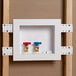A white Oatey Quadtro washing machine outlet box with two valves inside.